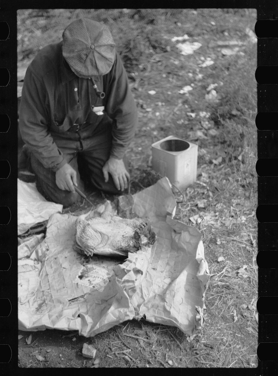 Man in a Minneapolis hobo jungle preparing a turtle for soup, September 1939