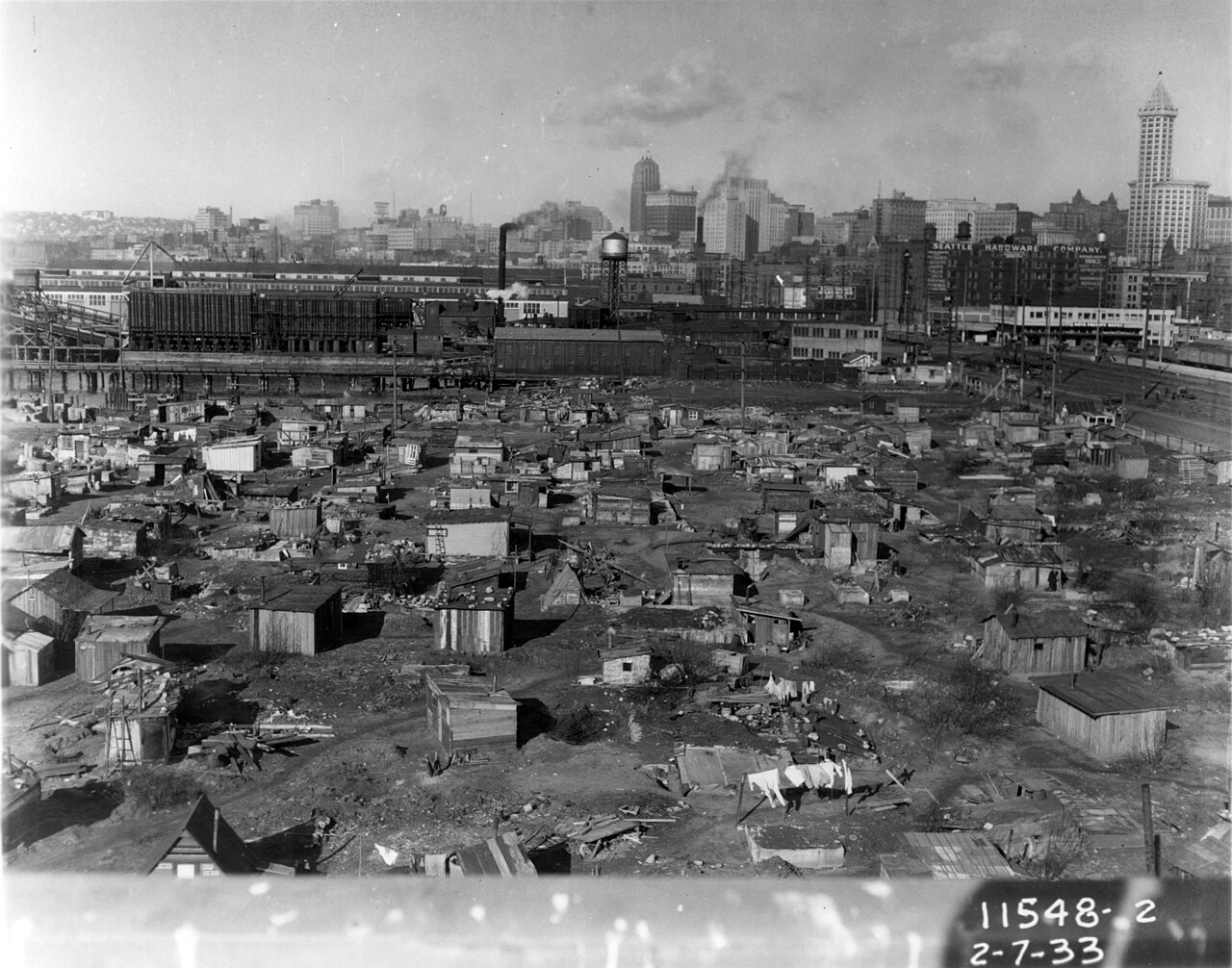 Hooverville shantytown on Seattle tideflats with downtown skyline beyond, 1933