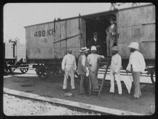 Seven men at the door of a freight car