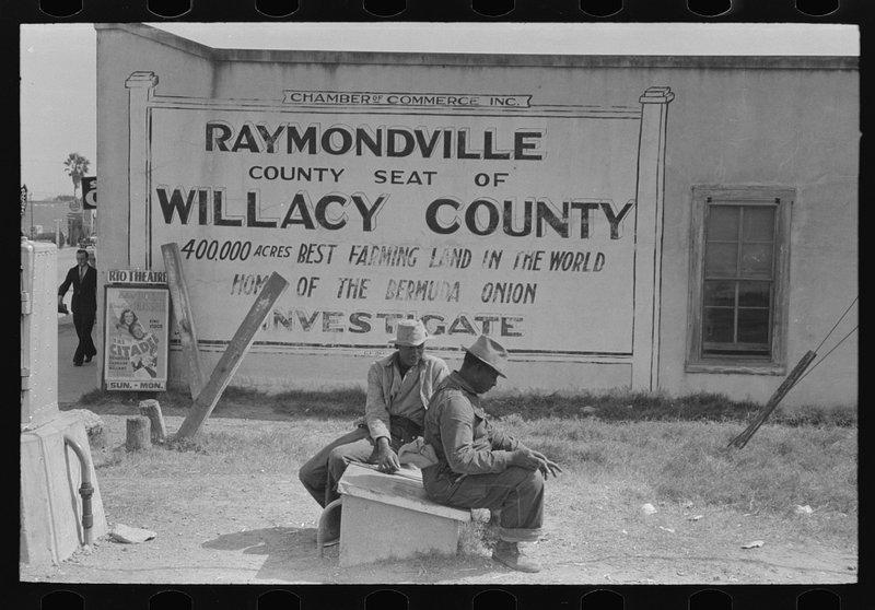 Negroes sitting along railroad tracks, Raymondville, Texas