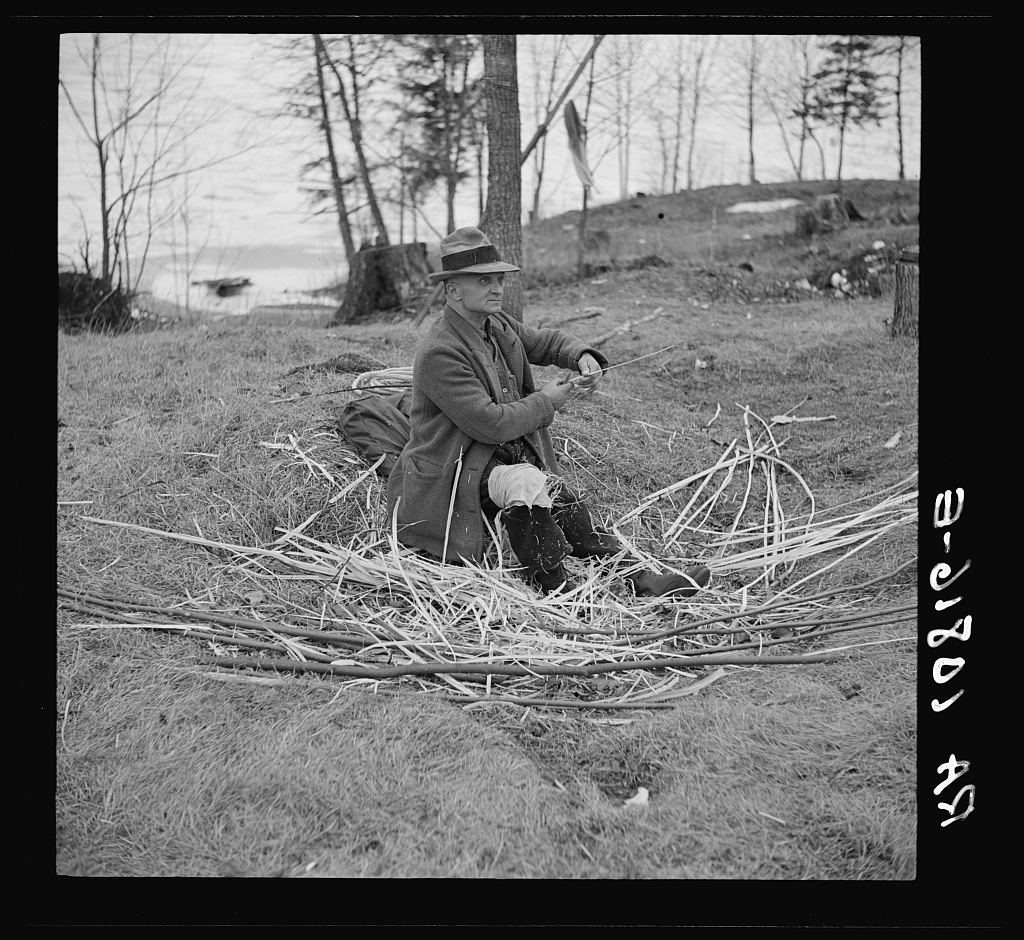Man making baskets at transient camp. Hagerman Lake, Michigan