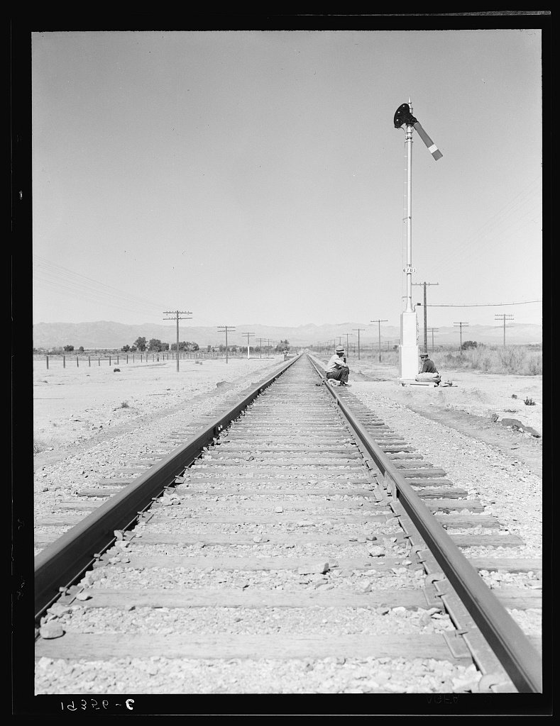 Itinerants with bindles waiting by the tracks near Calipatria, California
