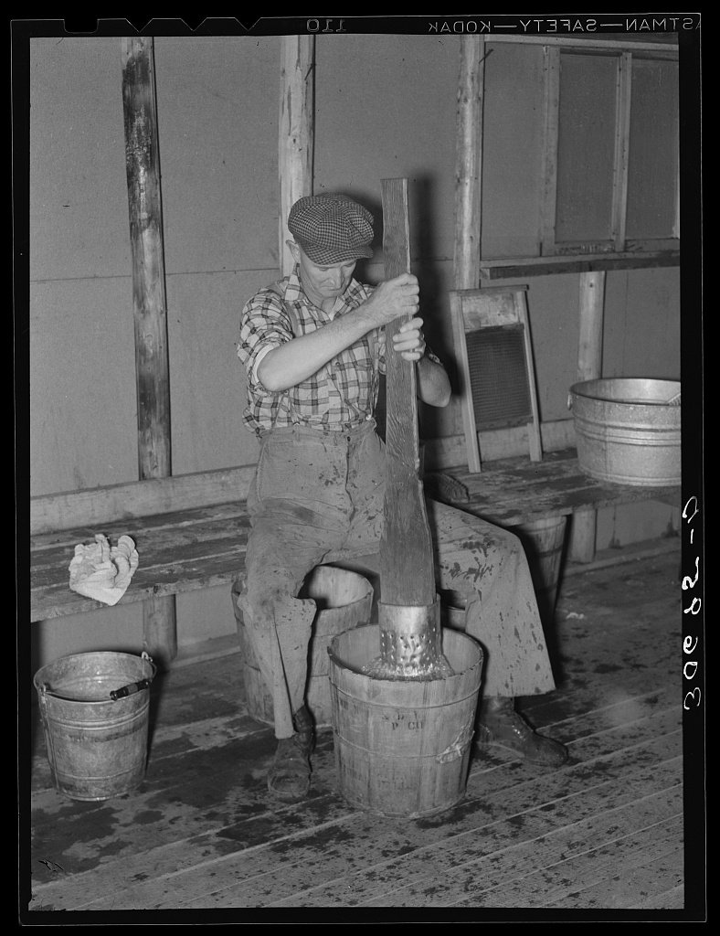 Lumberjack washing clothes at a logging camp near Effie, Minnesota
